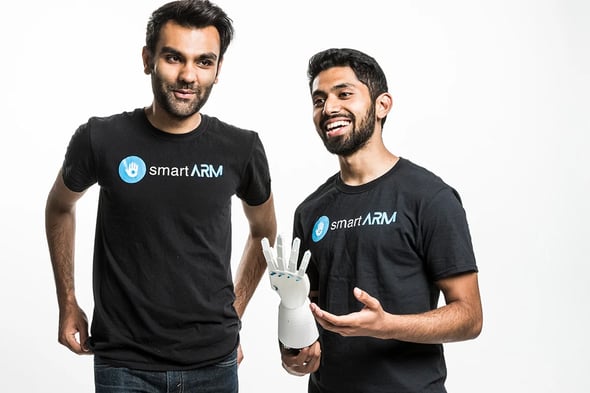 smartARM wins the Imagine World Cup Finals: Undergraduates Hamayal Choudhry from UOIT and Samin Khan from U of T, who is demonstrating the prosthetic against a white background.