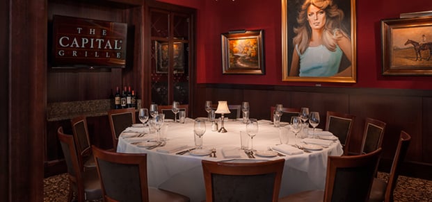 An interior photo of a large group table at The Capital Grille.
