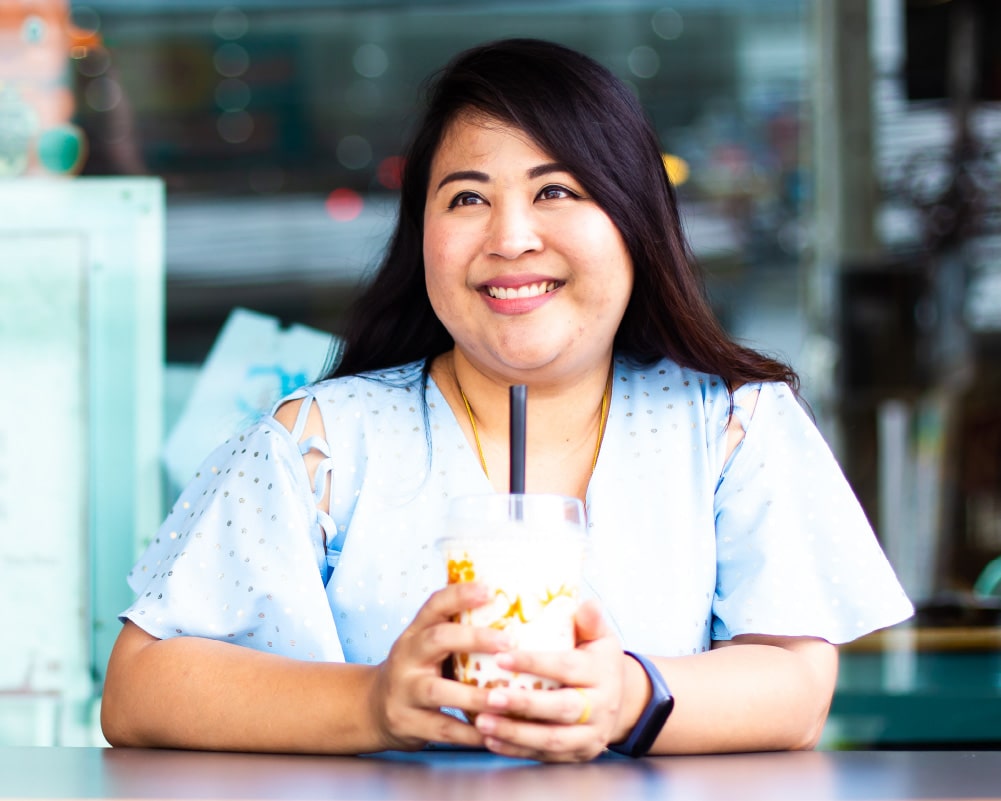 Woman smiling at a cafe