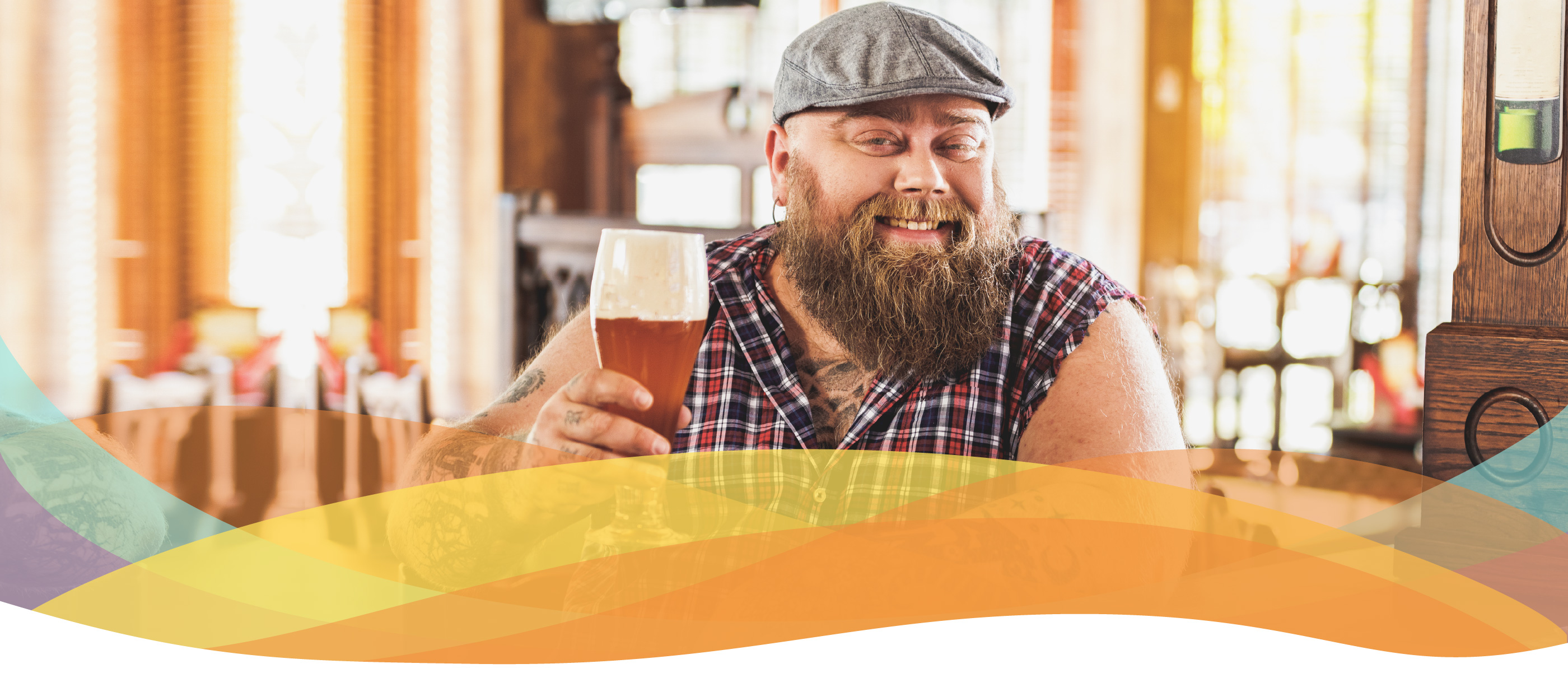 Plus-sized man with a long beard sits in a bar, raising his glass in 