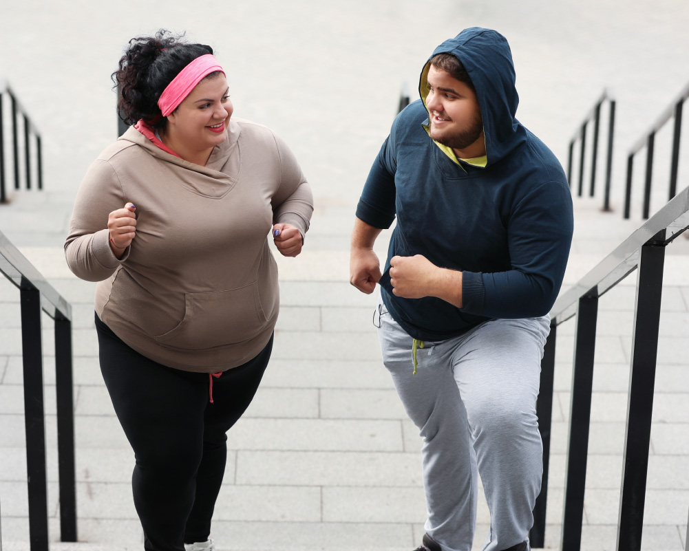 a plus size couple enjoy exercising together