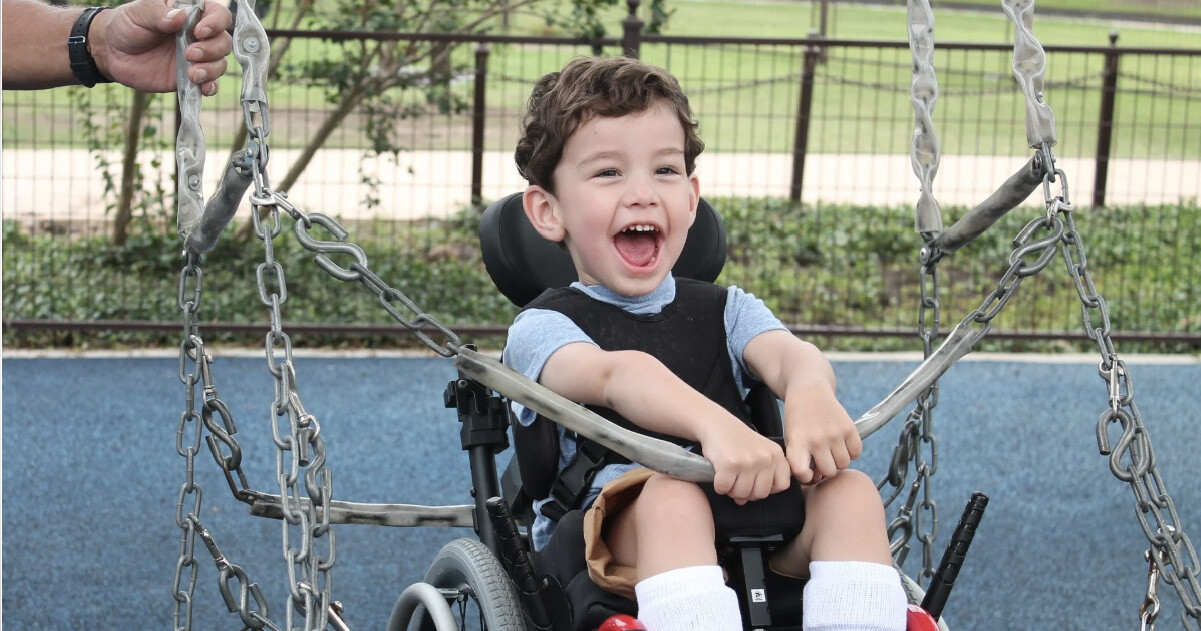 young boy enjoying a ride on the swing