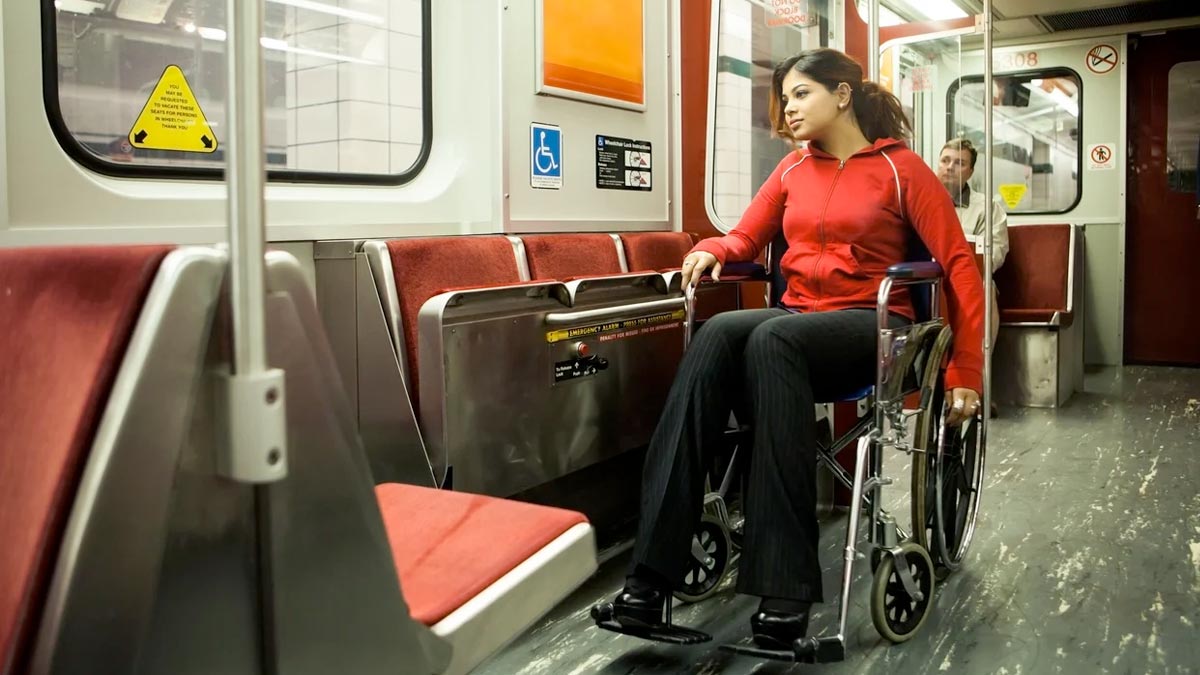 Latina woman rides the subway in a wheelchair