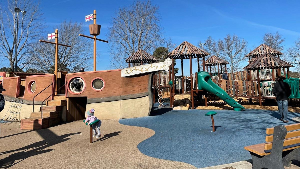 A playground for children of all abilities featuring an accessible pirate ship and wheelchair ramps.