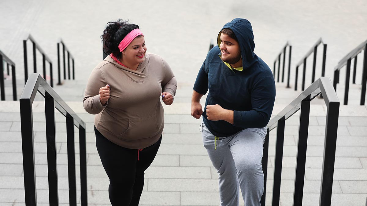 A plus size couple enjoy exercising together