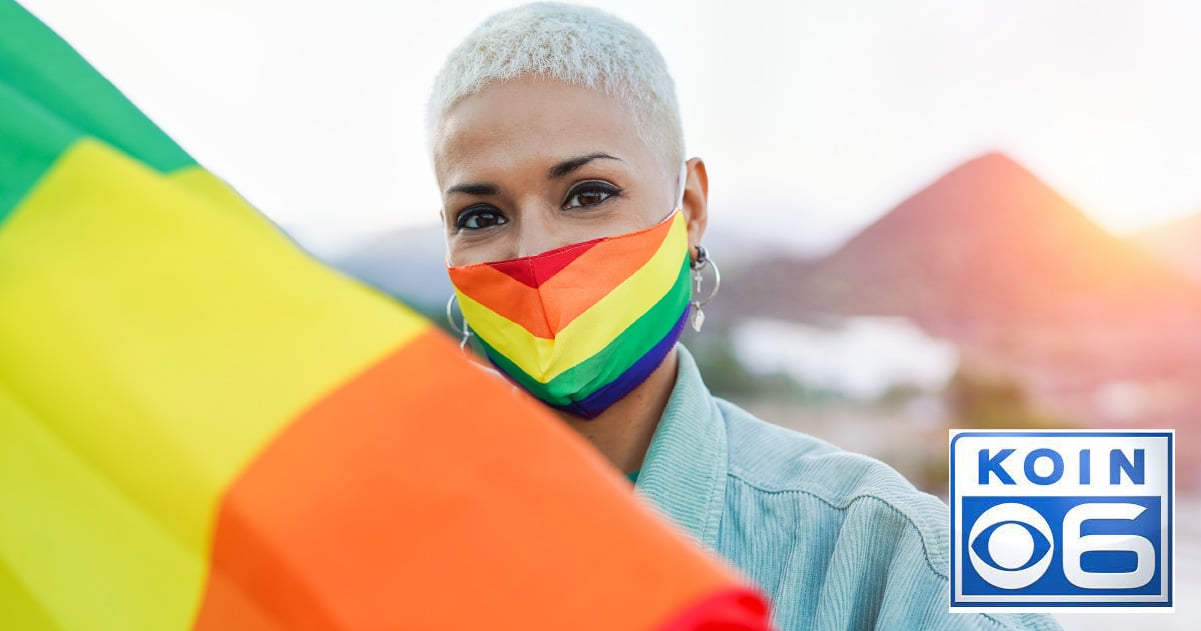 African American woman wears a rainbow pride Covid protection mask