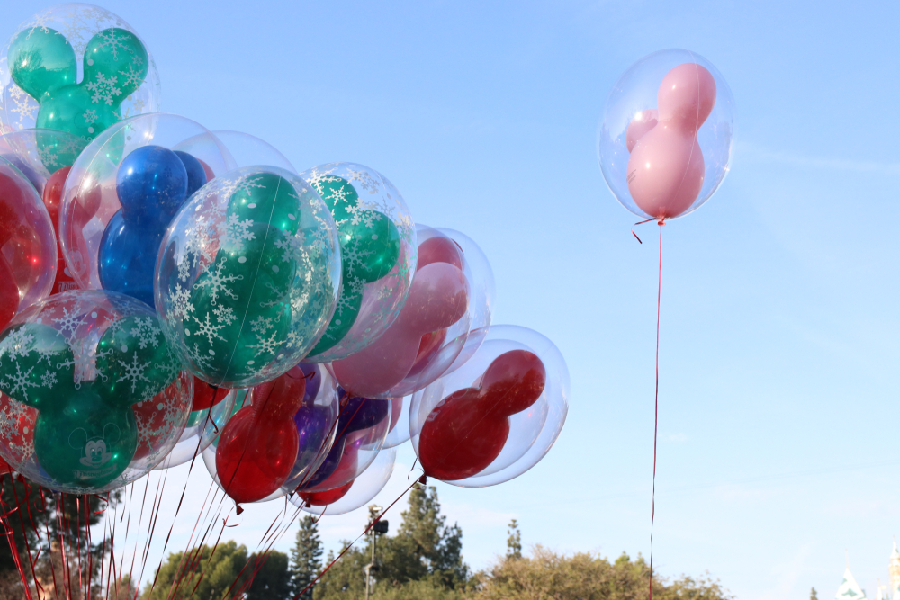 Colorful Mickey-shaped balloons against a blue sky.